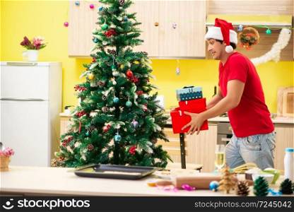Young man celebrating Christmas in kitchen 