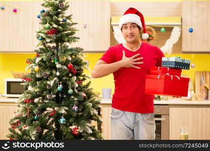 Young man celebrating Christmas in kitchen 