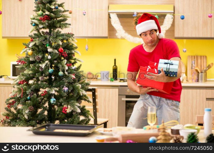 Young man celebrating Christmas in kitchen 