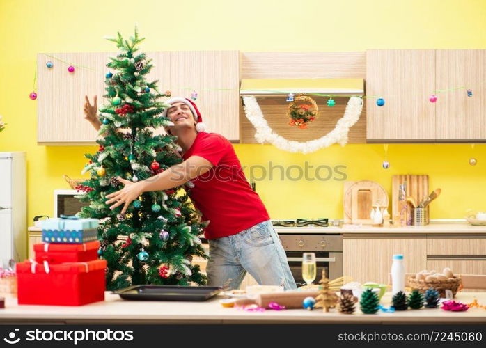 Young man celebrating Christmas in kitchen 