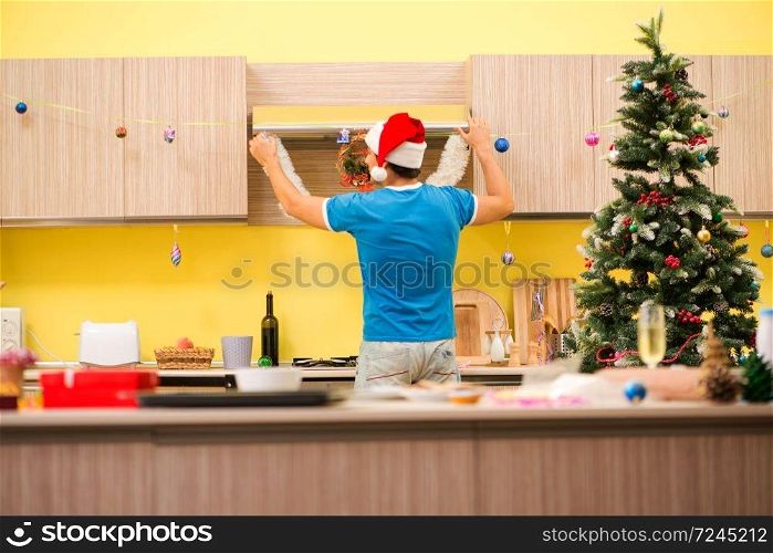 Young man celebrating Christmas in kitchen 