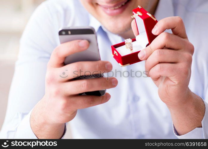 Young man chatting with his sweetheart over mobile phone