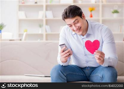 Young man chatting with his sweetheart over mobile phone