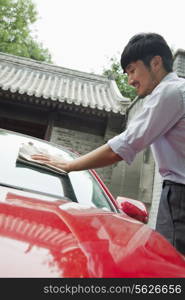 Young Man Cleaning His Car