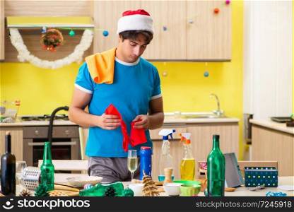 Young man cleaning kitchen after Christmas party . The young man cleaning kitchen after christmas party 