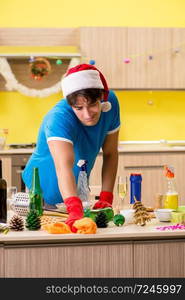 Young man cleaning kitchen after Christmas party . The young man cleaning kitchen after christmas party 