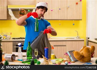 Young man cleaning kitchen after Christmas party . The young man cleaning kitchen after christmas party 