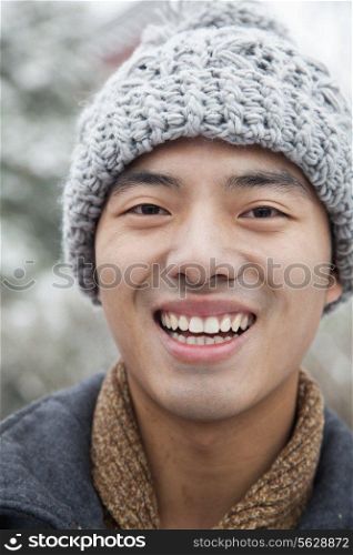 Young man Close-up portrait in snow