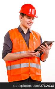 Young man construction worker builder in orange safety vest and red hard hat using tablet touchpad isolated on white. Technology in industrial work. Studio shot.