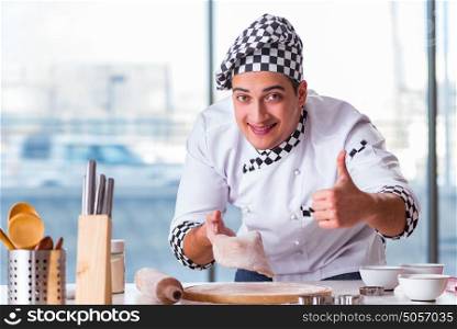 Young man cooking cookies in kitchen
