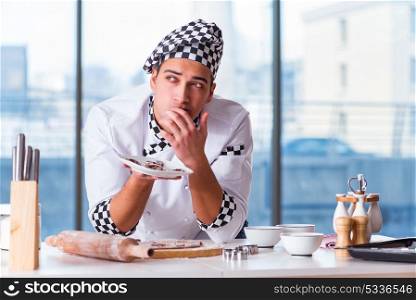 Young man cooking cookies in kitchen