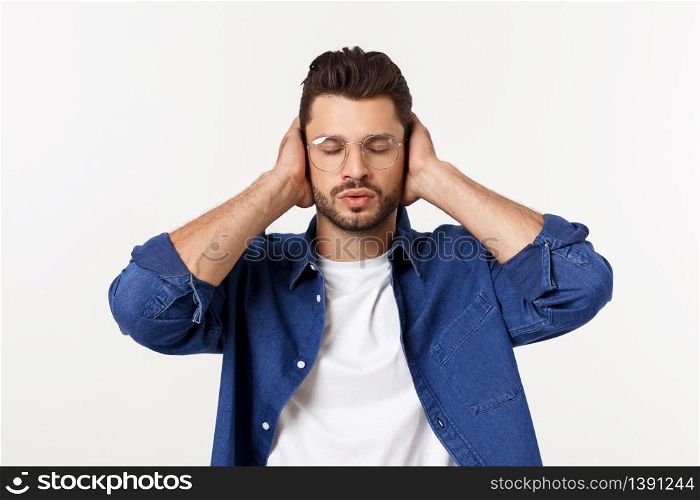 young man covering his ears, closing his eyes, isolated on white background. Hear no evil concept. Emotions facial expressions and communication sign.. young man covering his ears, closing his eyes, isolated on white background. Hear no evil concept. Emotions facial expressions and communication sign