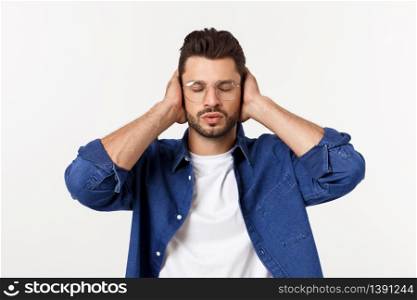 young man covering his ears, closing his eyes, isolated on white background. Hear no evil concept. Emotions facial expressions and communication sign.. young man covering his ears, closing his eyes, isolated on white background. Hear no evil concept. Emotions facial expressions and communication sign