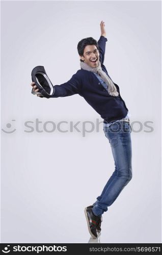 Young man dancing over colored background