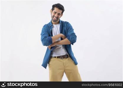 Young man dancing while listening music using earbuds and mobile
