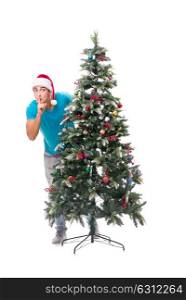 Young man decorating christmas tree isolated on white. The young man decorating christmas tree isolated on white