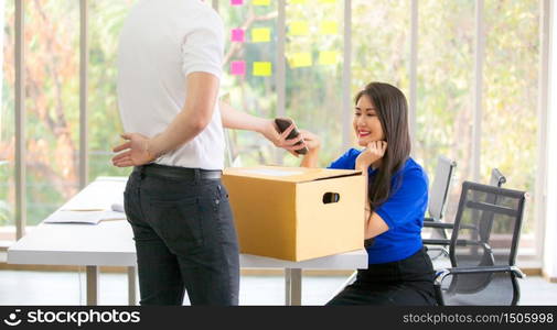 Young man delivered the parcel. Courier with a cardboard box. Parcel Delivery Service.