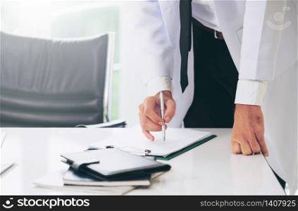 Young man doctor working at office desk in hospital. Medical and healthcare concept.. Young man doctor working at office in hospital.
