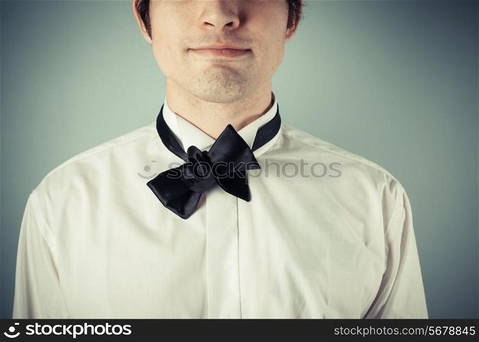 Young man does not know how to tie a bow tie