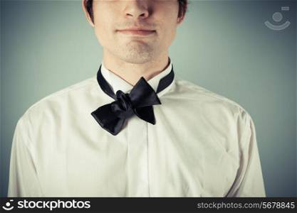 Young man does not know how to tie a bow tie