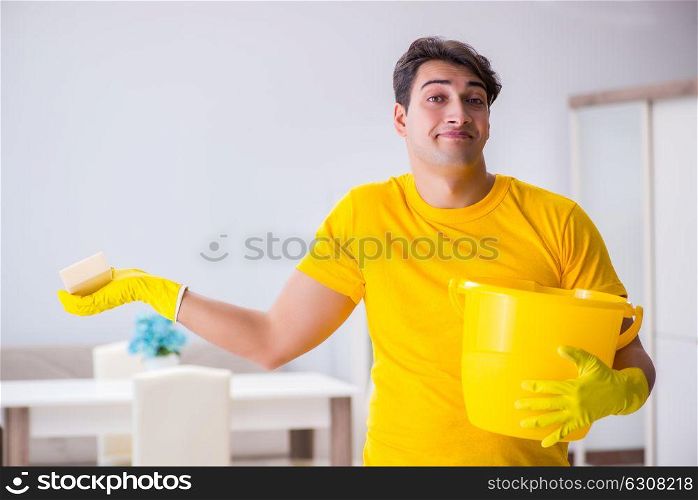 Young man doing chores at home