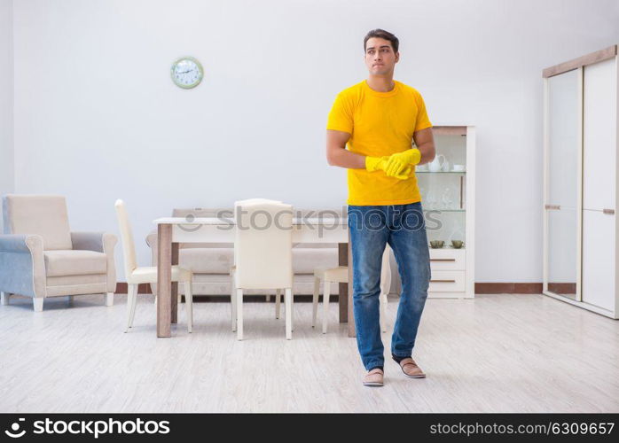 Young man doing chores at home