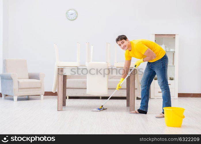 Young man doing chores at home