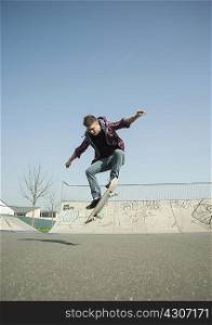 Young man doing skateboarding trick