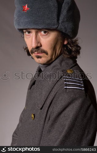 young man dressed as russian military, studio picture