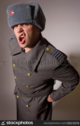 young man dressed as russian military, studio picture