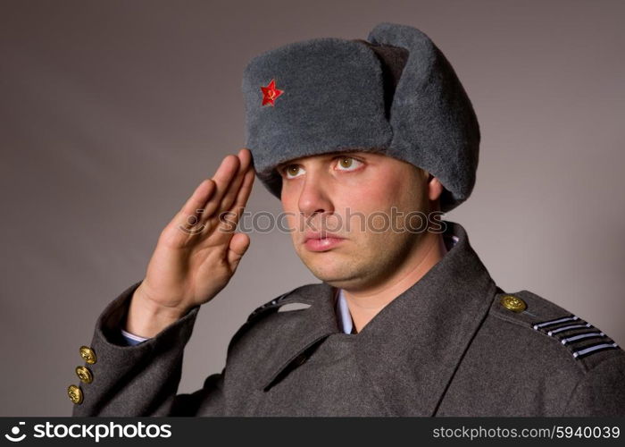 young man dressed as russian military, studio picture