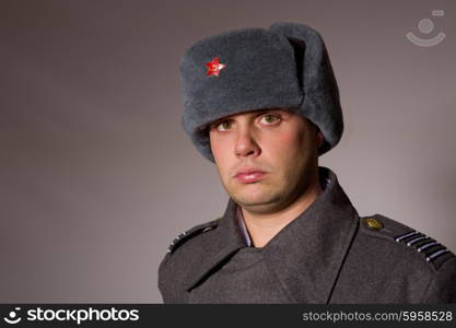 young man dressed as russian military, studio picture