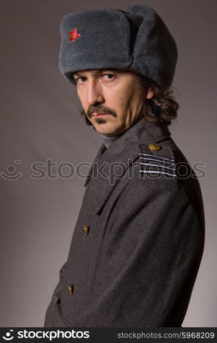 young man dressed as russian military, studio picture