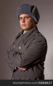 young man dressed as russian military, studio picture