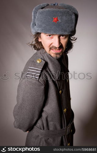 young man dressed as russian military, studio picture