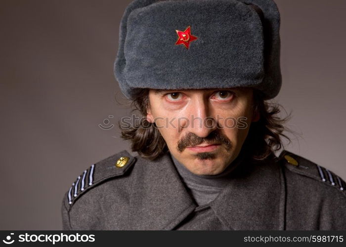 young man dressed as russian military, studio picture