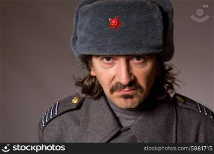 young man dressed as russian military, studio picture
