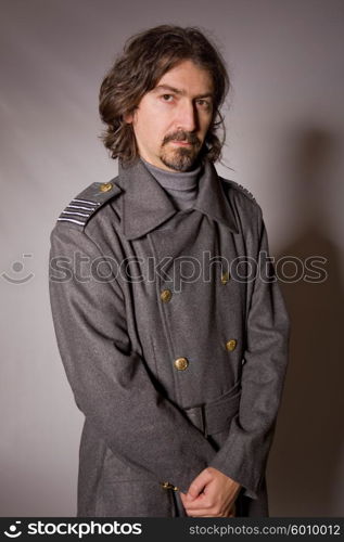 young man dressed as russian military, studio picture