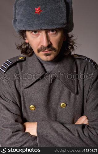 young man dressed as russian military, studio picture