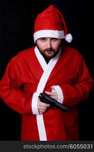 young man dressed as santa with a gun