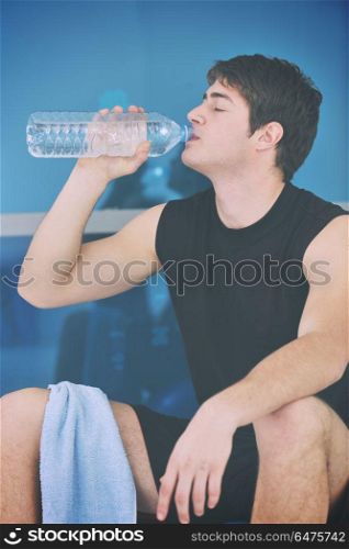 young man drink water at fitness workout training at sport club. man drink water at fitness workout