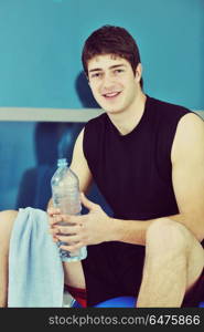 young man drink water at fitness workout training at sport club. man drink water at fitness workout