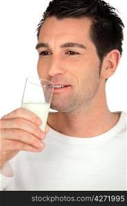 Young man drinking a glass of milk