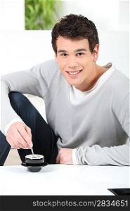 Young man drinking an expresso at home