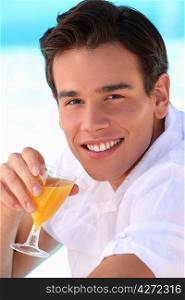 Young man drinking orange juice