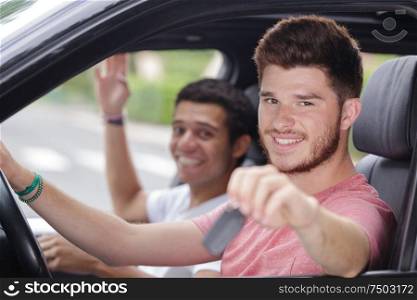 young man driving behind the wheel of the car