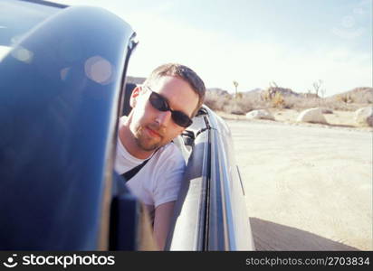 Young man driving car, portrait