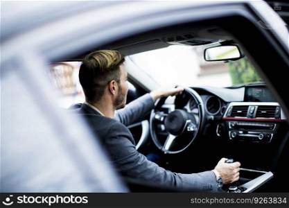 Young man driving in the  modern car