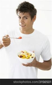 Young Man Eating Fresh Fruit Salad