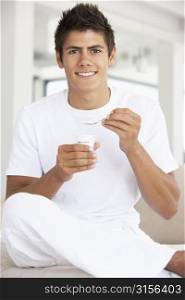 Young Man Eating Yogurt